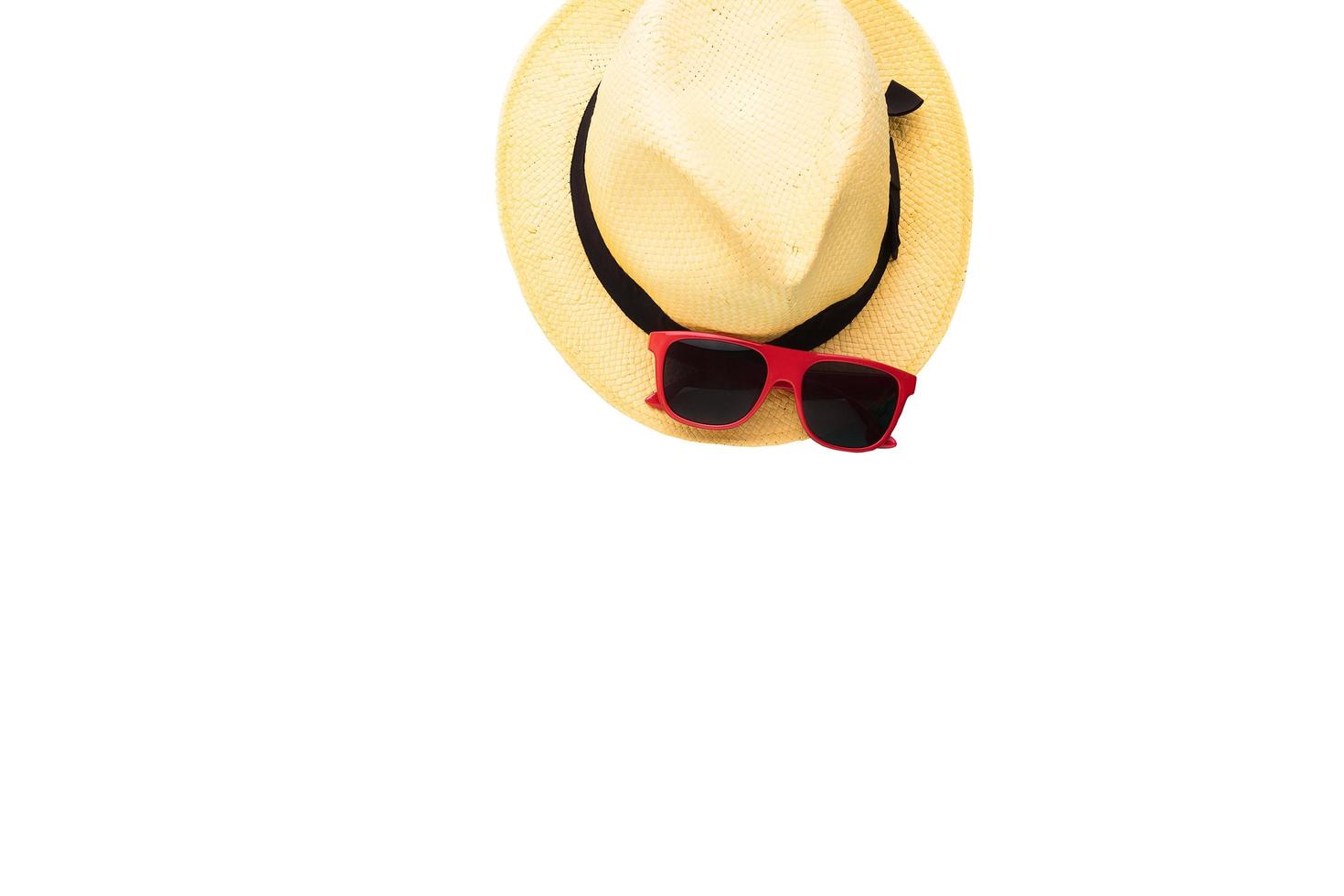 Summer accessories isolated on white. Top view and fashion background. Hat and sunglasses photo