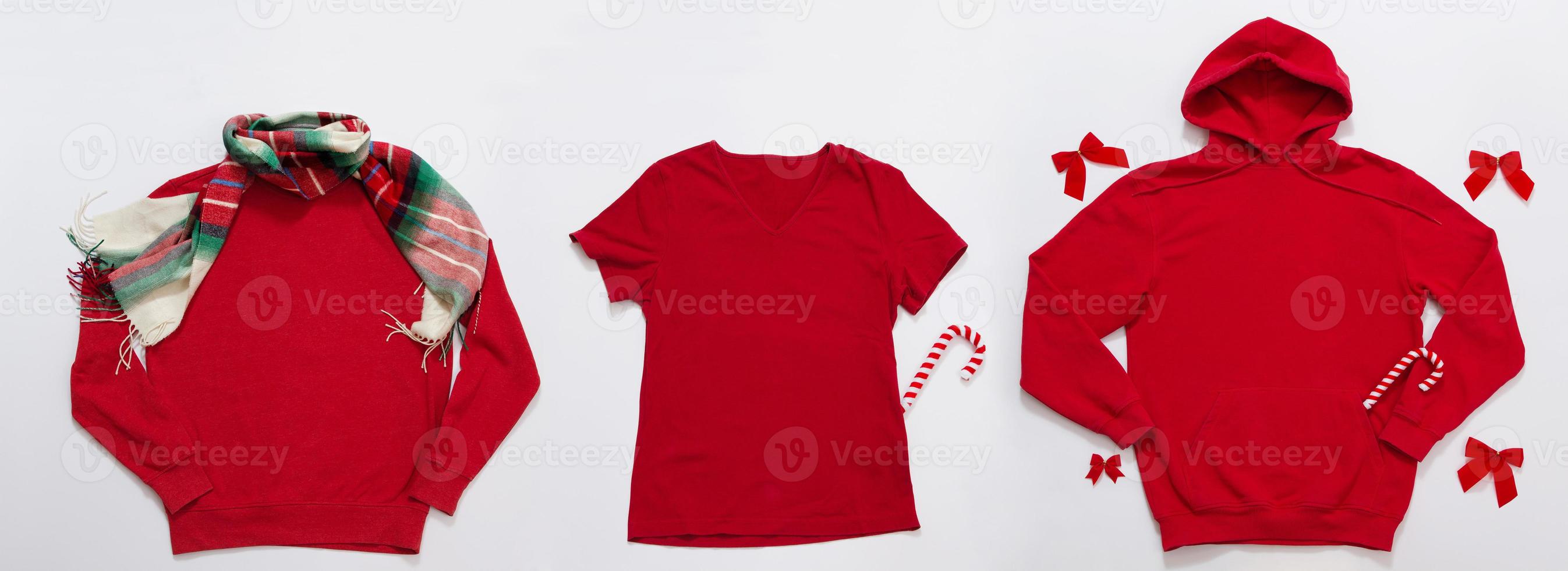 Close up banner red blank template sweatshirt, hoodie, t shirt with copy space and Christmas Holiday concept. Top view mockup. Holidays decorations on white background. Happy New Year clothes. Xmas photo