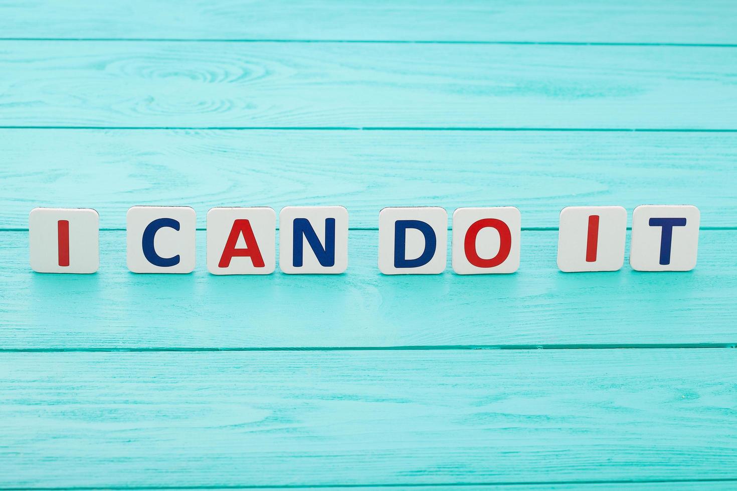 Words of motivation. I can do it. Blue wooden background, selective focus and copy space photo