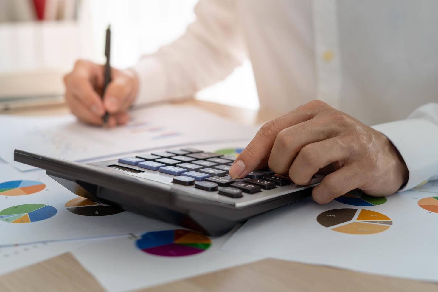 Business men looking at charts, spreadsheets, graph financial development, bank accounts, statistics, economy, data analysis, investment analysis, stock exchange photo