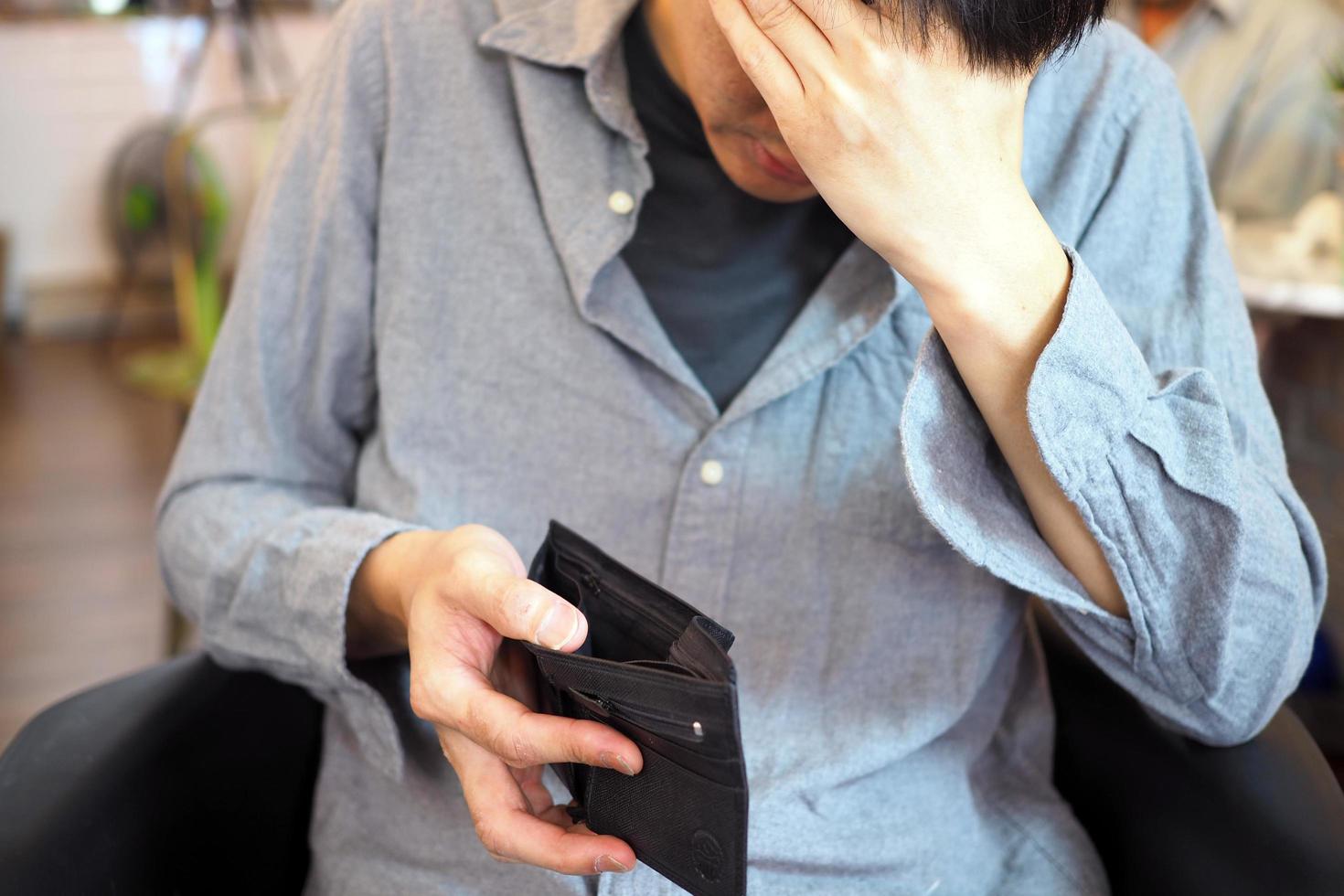 Man's hands open empty purse. Poverty, debt and bankruptcy in the payment of bills and credit cards. Broke concept photo