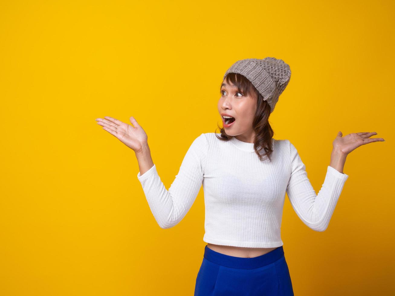 The girl is standing, surprised, wow, excited, has a yellow wall. photo