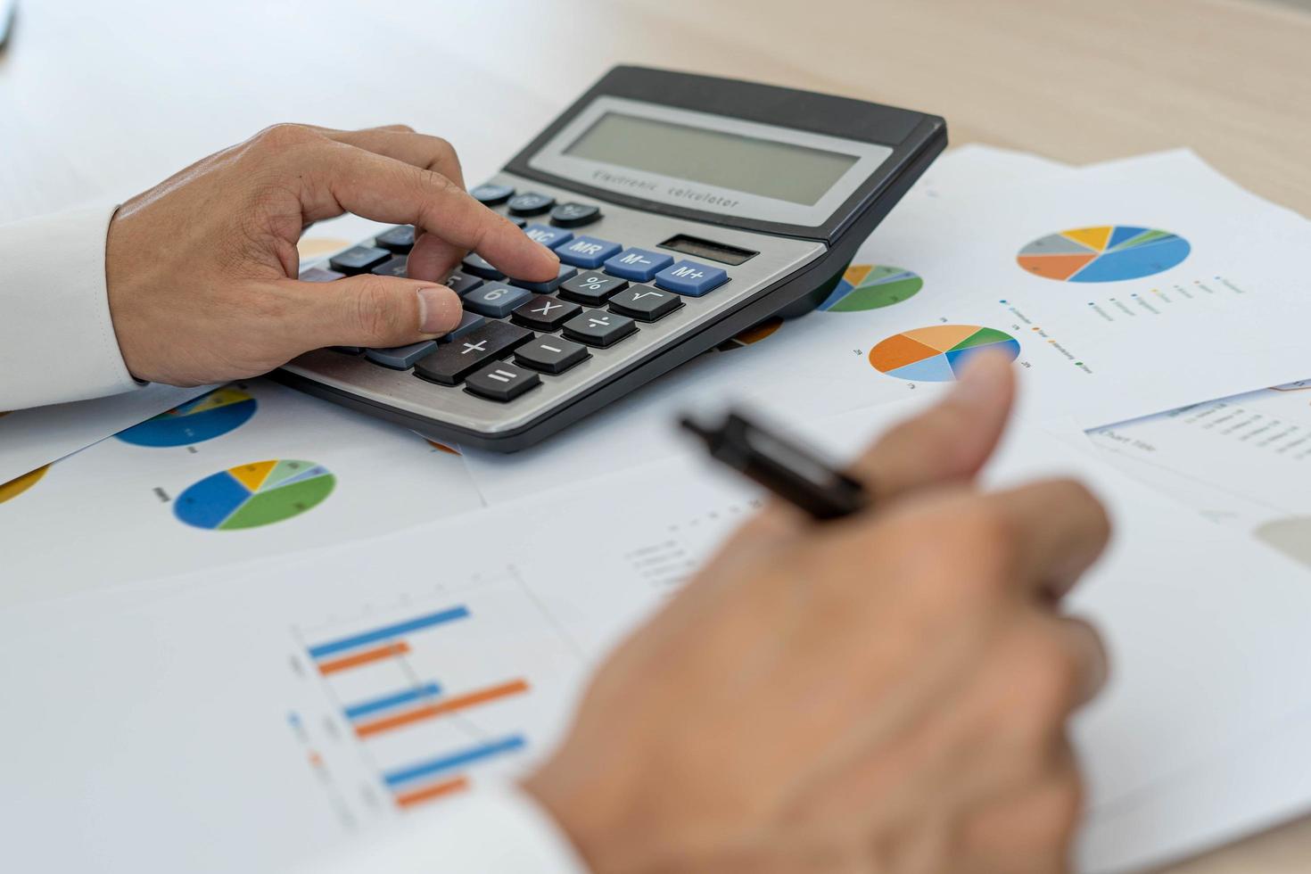 Business men looking at charts, spreadsheets, graph financial development, bank accounts, statistics, economy, data analysis, investment analysis, stock exchange photo