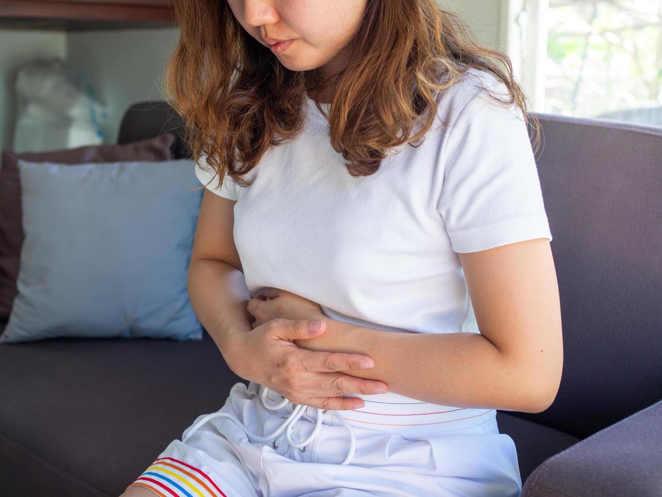 A woman has severe stomach pain. Menstrual cramps photo