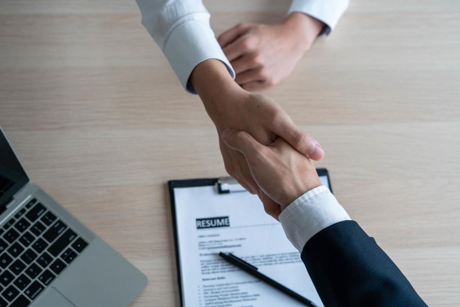 Businessmen and job seekers shake hands after agreeing to accept a job and approve it as an employee in the company. Or a joint venture agreement between the two businessmen photo