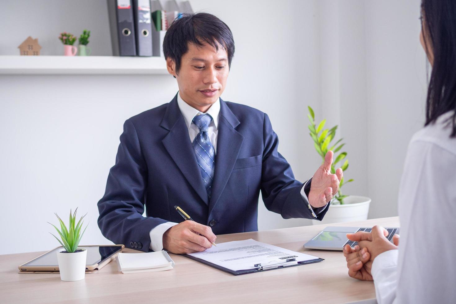 Executives are interviewing job applicants to accept new job flaps to work in vacancies. Discuss the applicant's work history and ability. photo