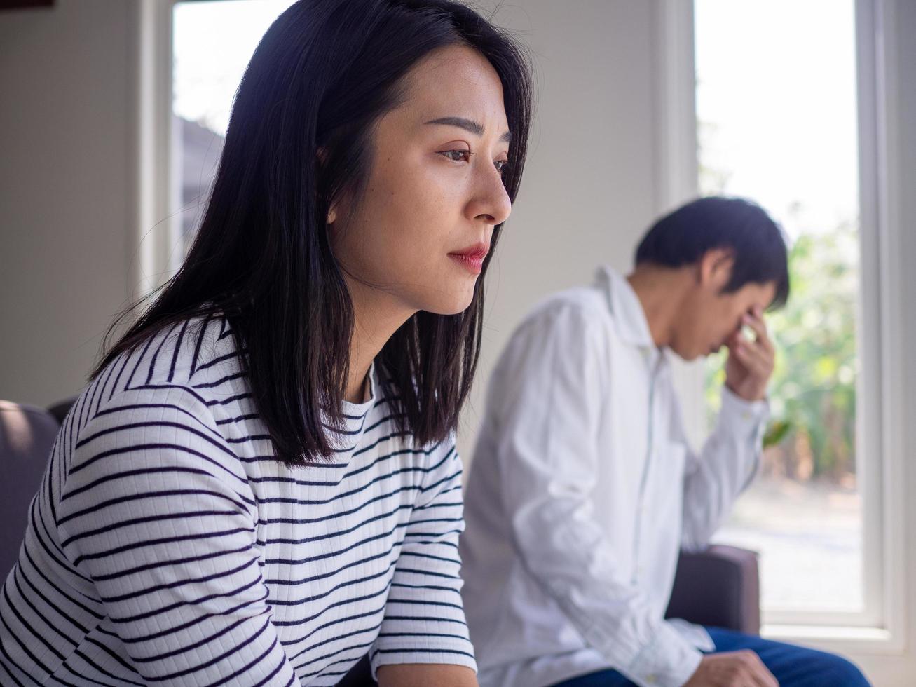 Asian women mourn and become irritated by their husband's behavior. After an argument and causing pain in the heart. Angry and not understanding each other, resulting to divorce photo