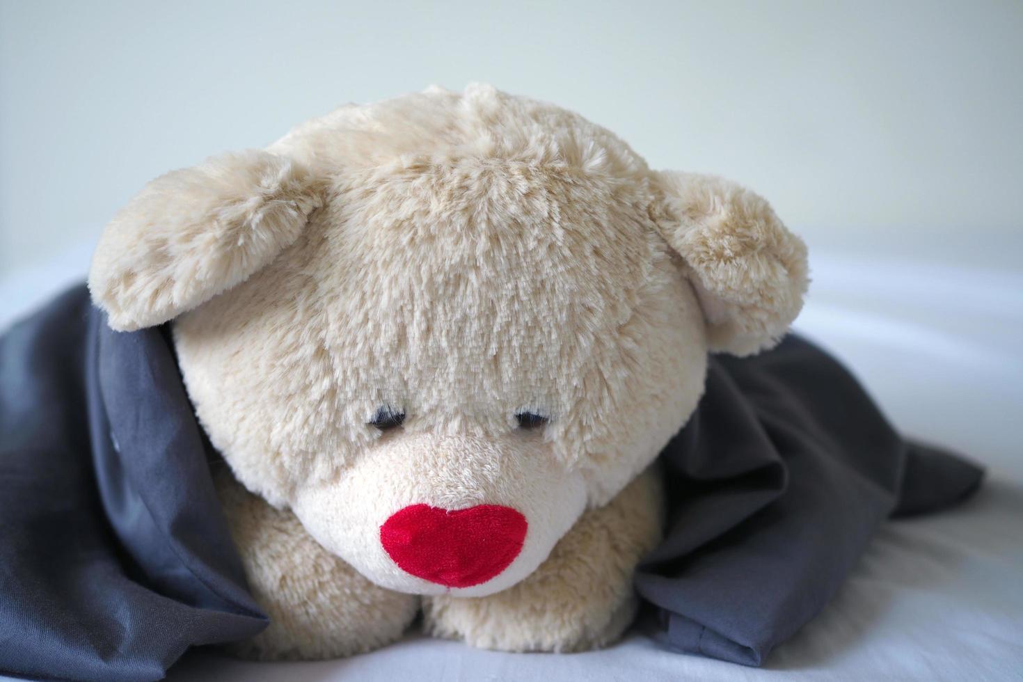 The concept of child sorrow Teddy bear lying alone, sad and disappointed photo