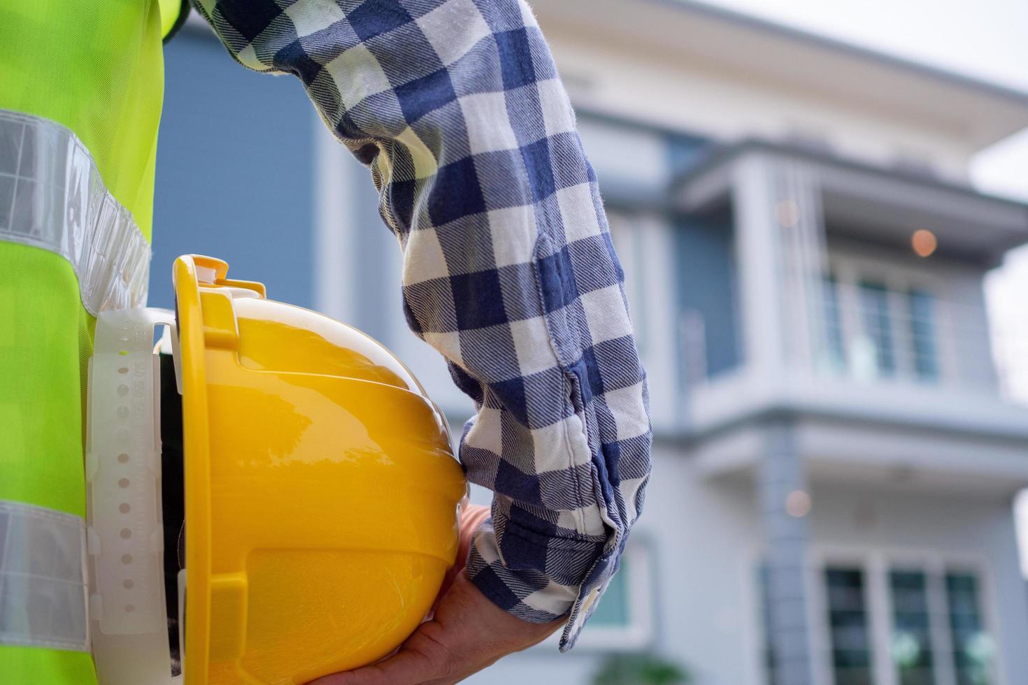 Male contractor is looking at the house project area that has been assigned to do. Check the preparation of the house before sending it to the homeowner . photo