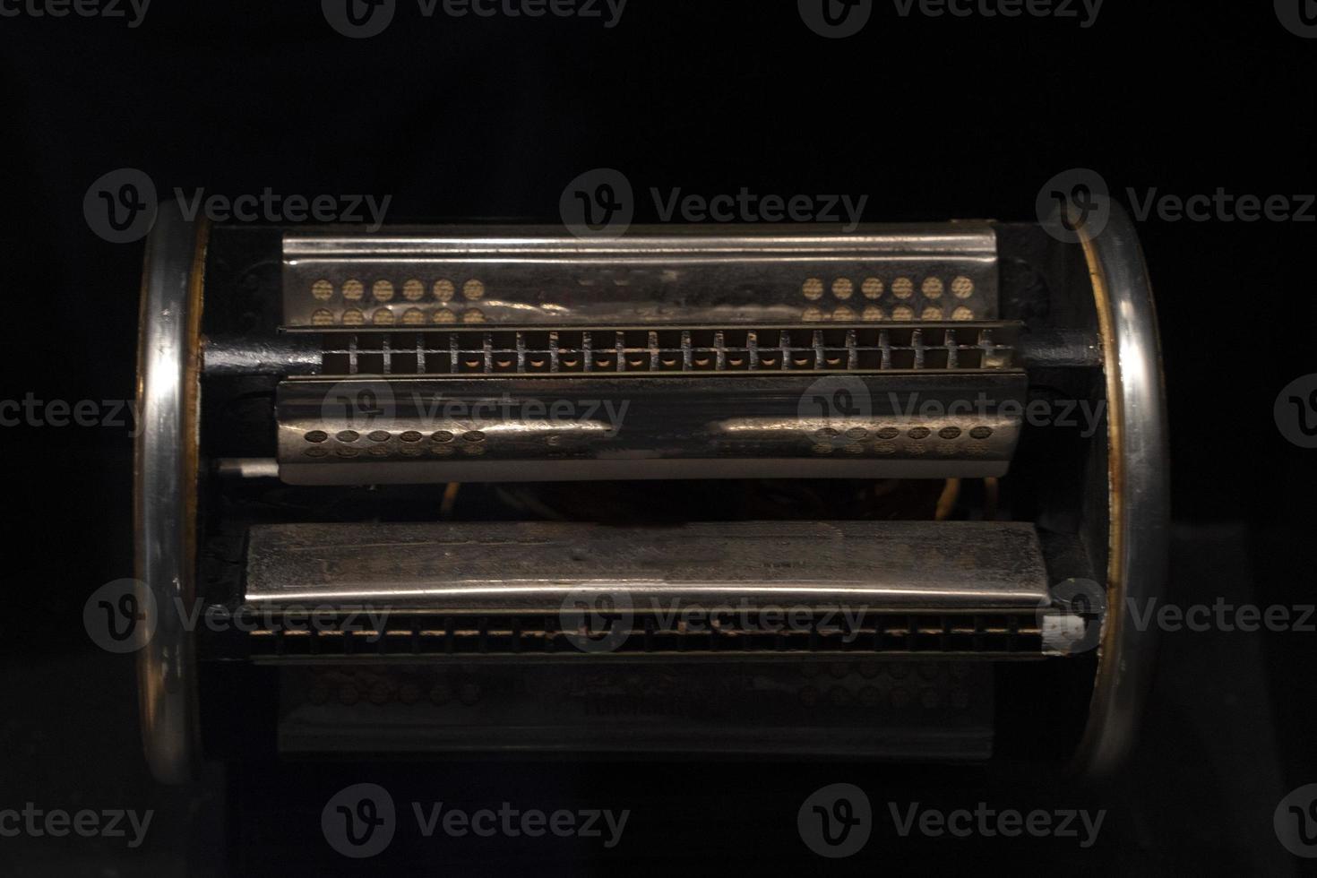 six sided harmonica isolated on black photo