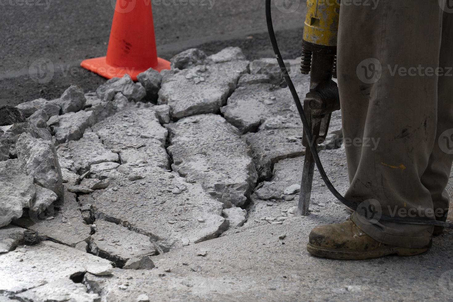 Man working with jackhammer on the road photo