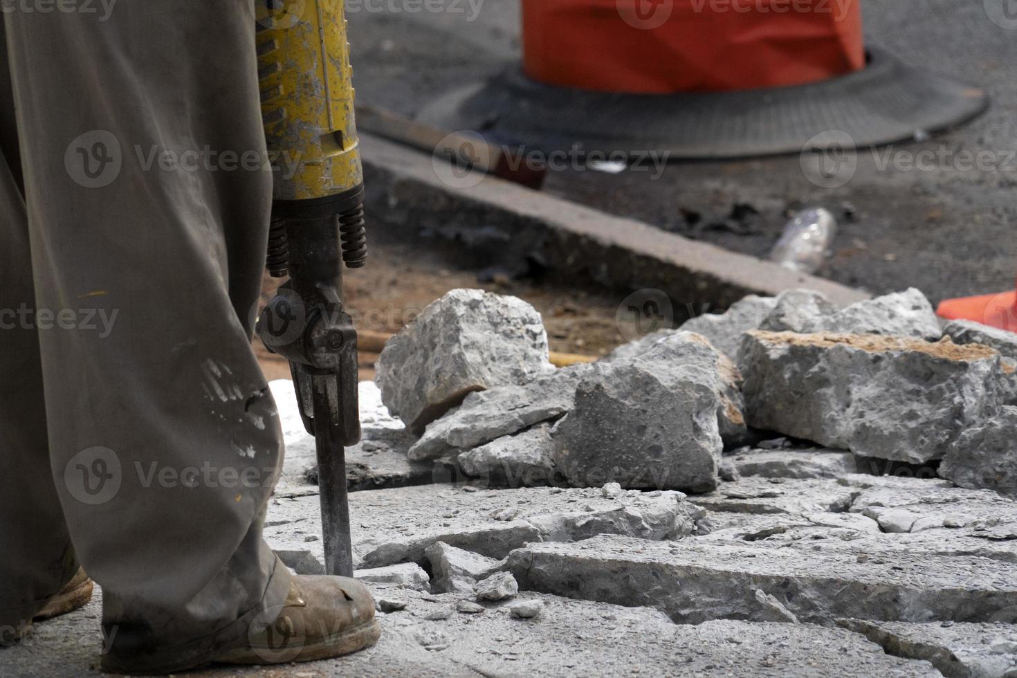 Man working with jackhammer on the road photo