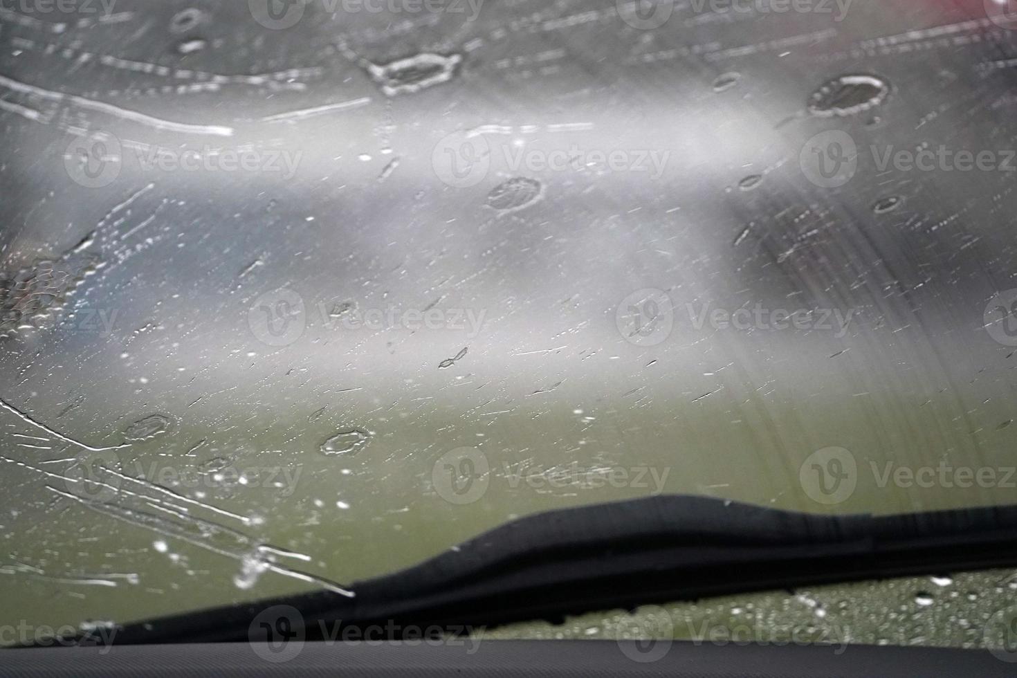 heavy rain on car windscreen wiper photo