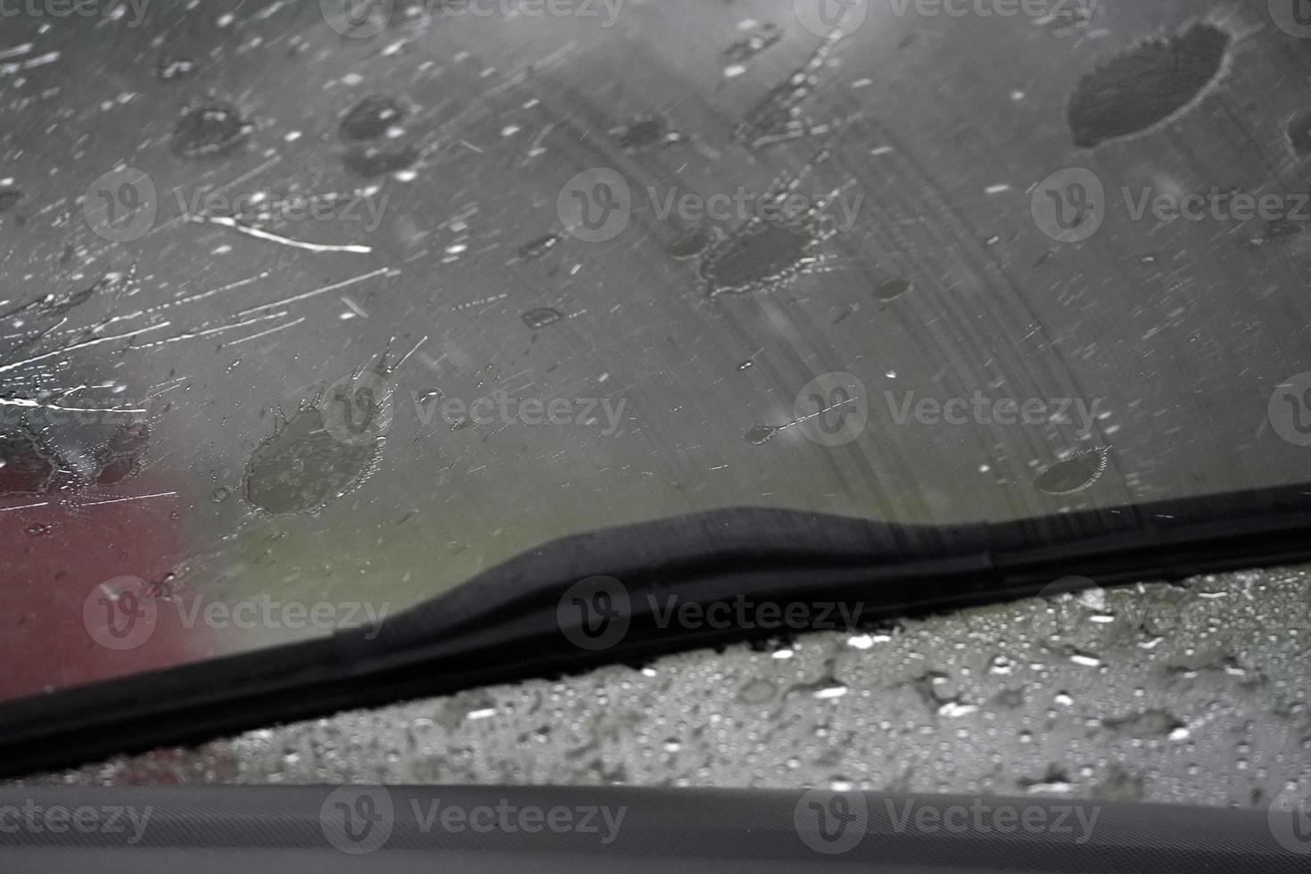 heavy rain on car windscreen wiper photo