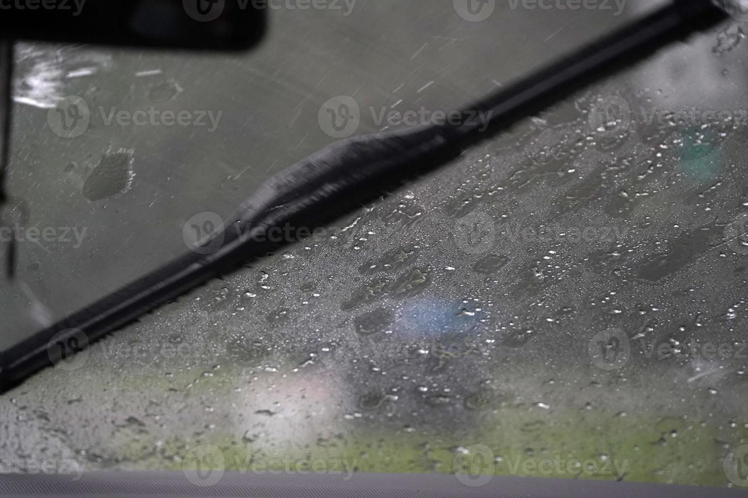 heavy rain on car windscreen wiper photo