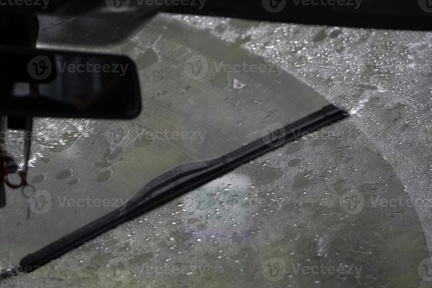 heavy rain on car windscreen wiper photo