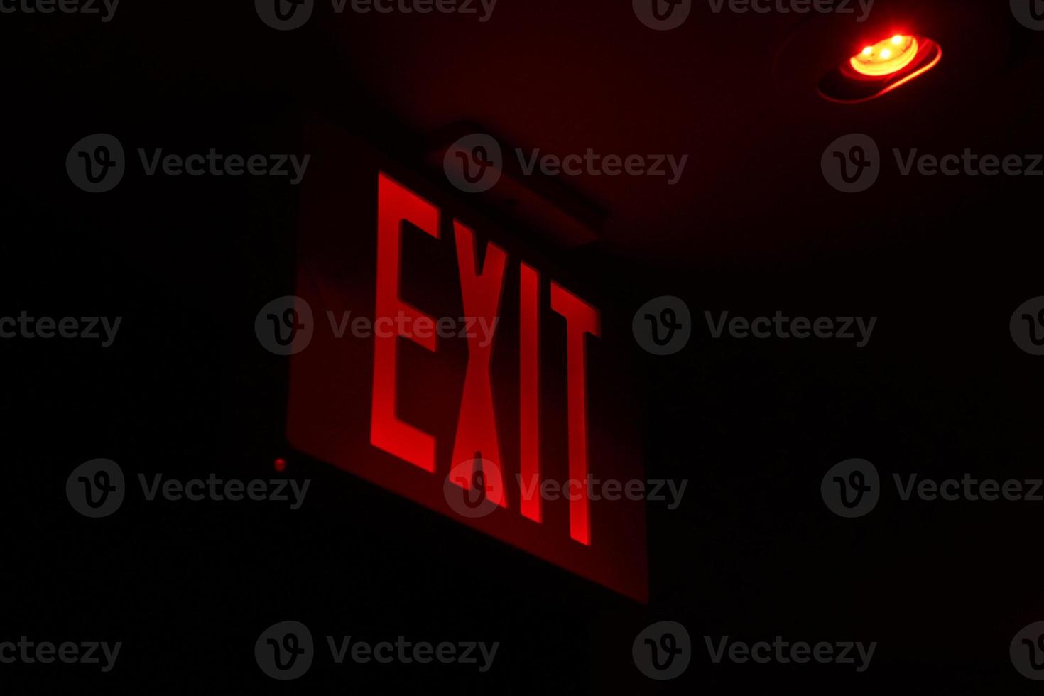 exit red light sign on black photo