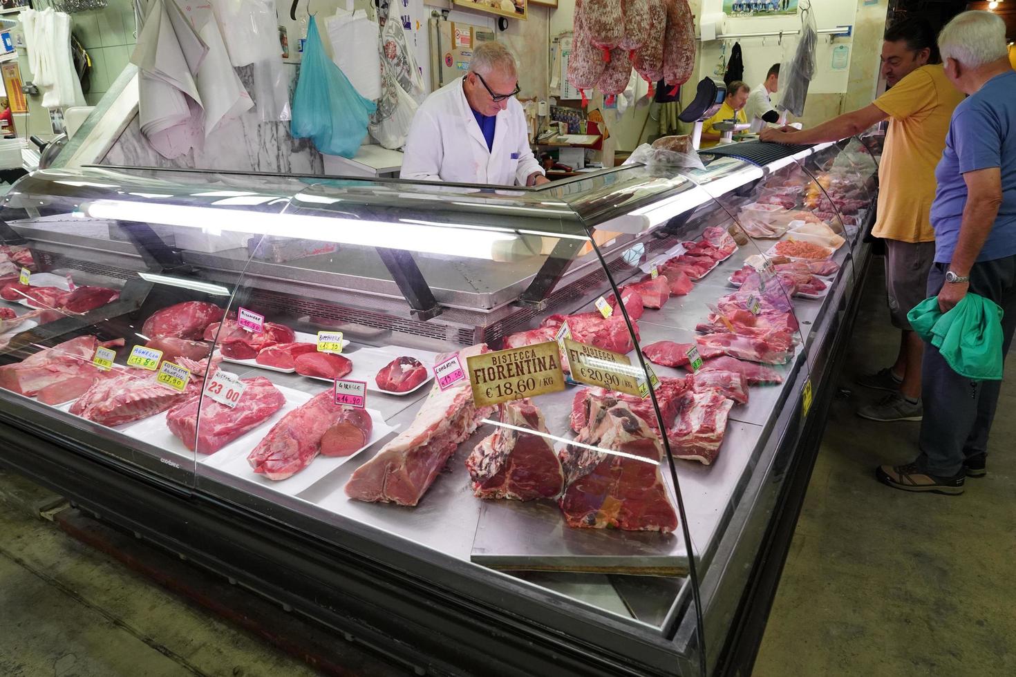 FLORENCE, ITALY - SEPTEMBER 1 2018 - People buying at old city market photo