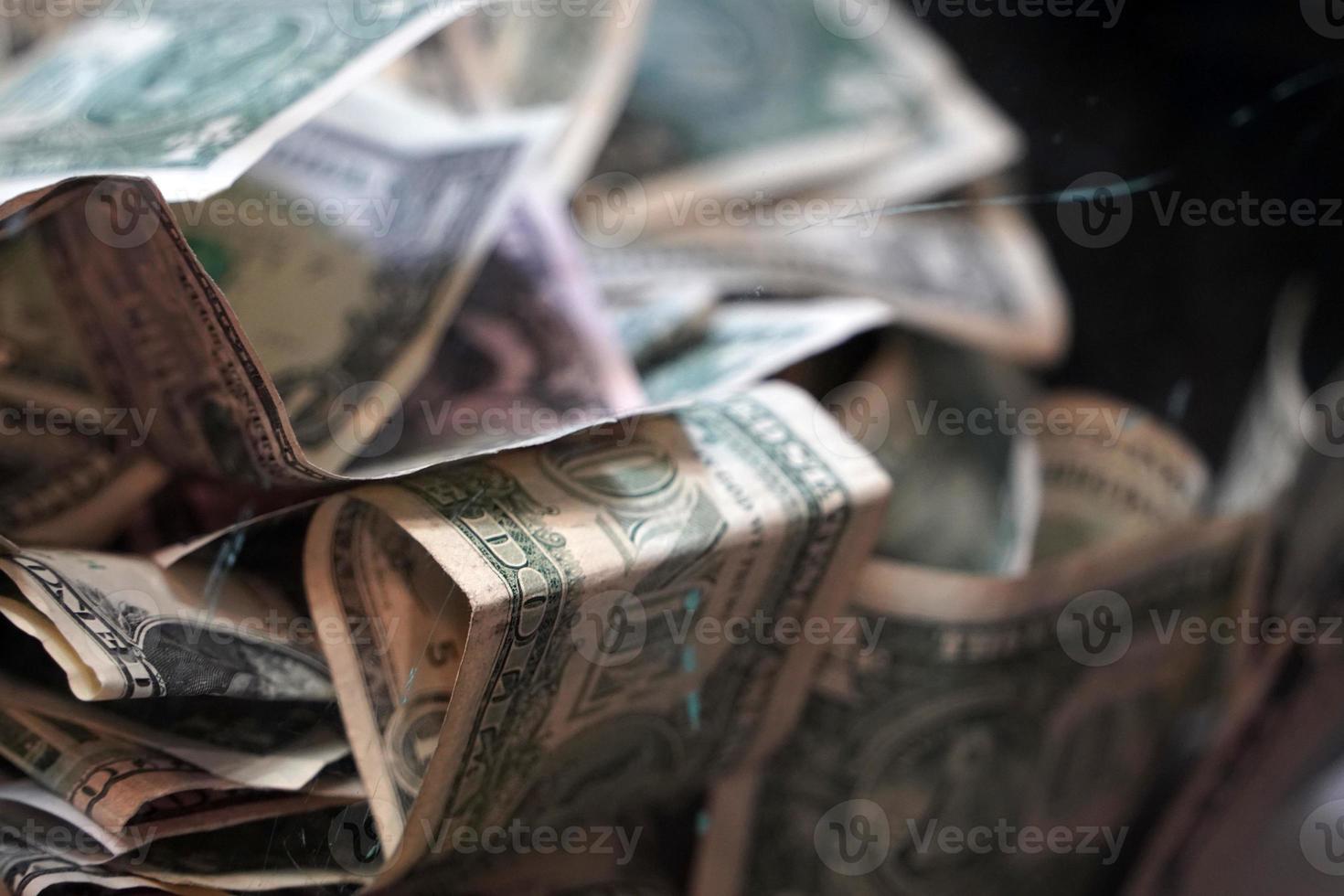dollars inside transparent tip box photo