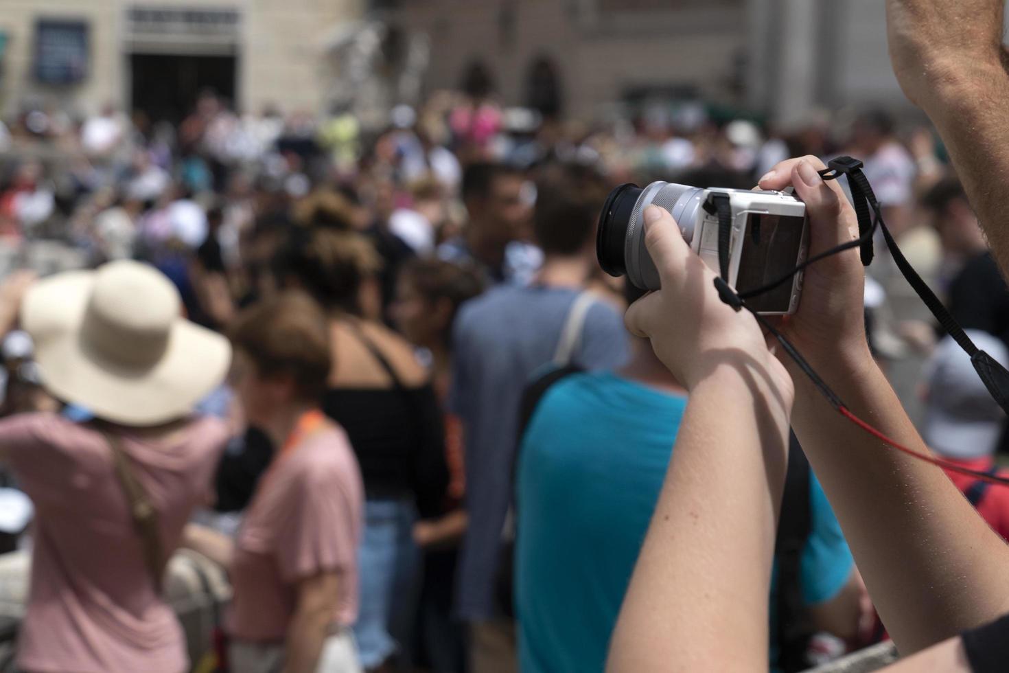 ROME, ITALY - JUNE 15 2019 - Tourist taking selfie at Fontana di Trevi fountain photo