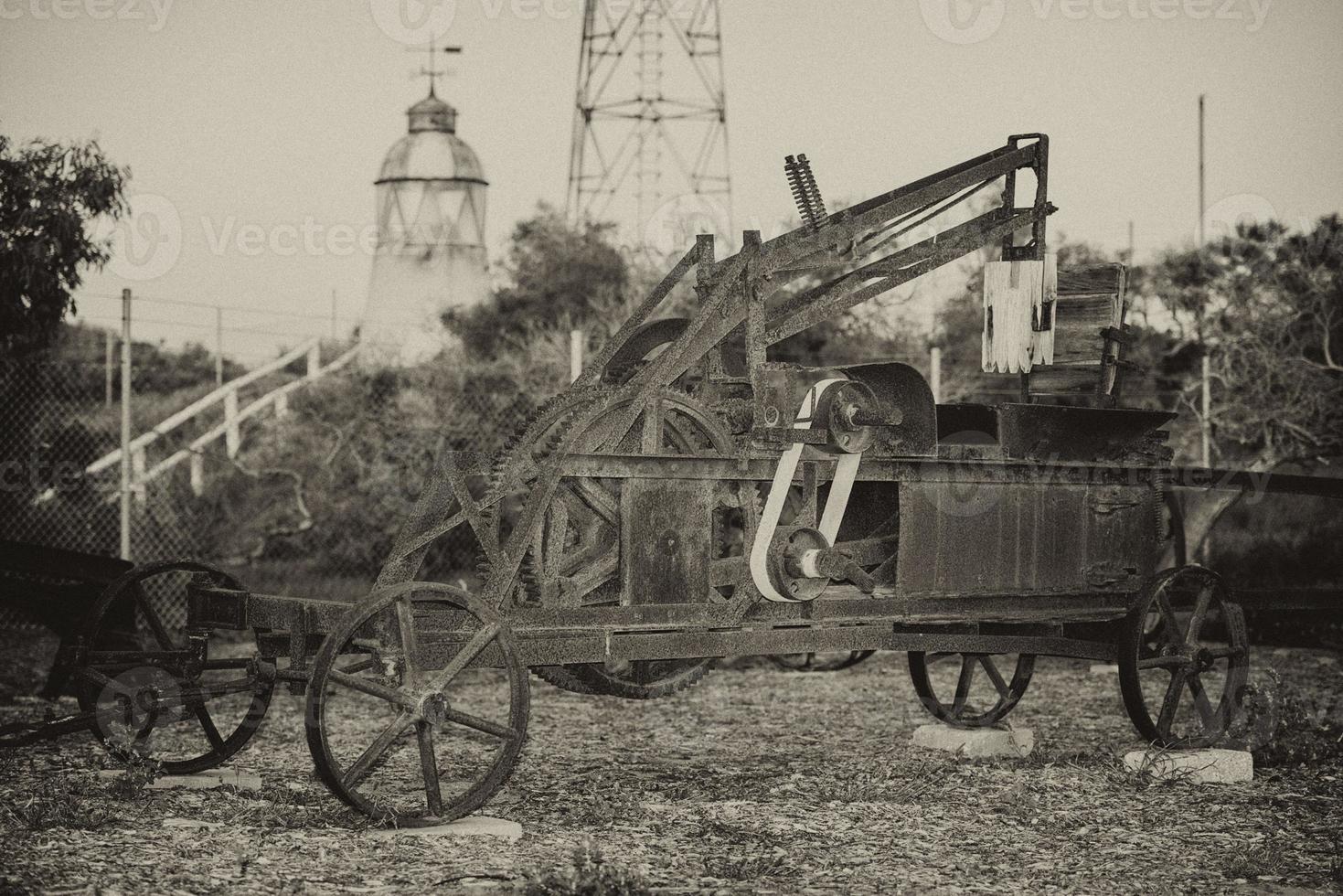 Old rusted antique tractor detail in black and white photo