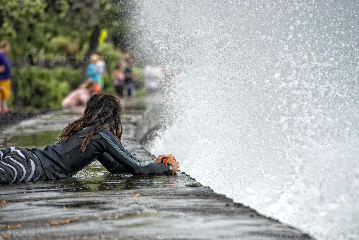 Rasta man photographing sea wave photo