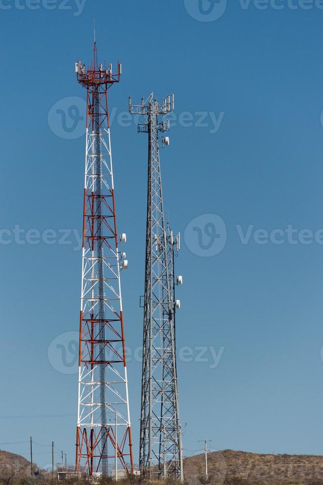 Communication Antenna on the light blue sky background photo