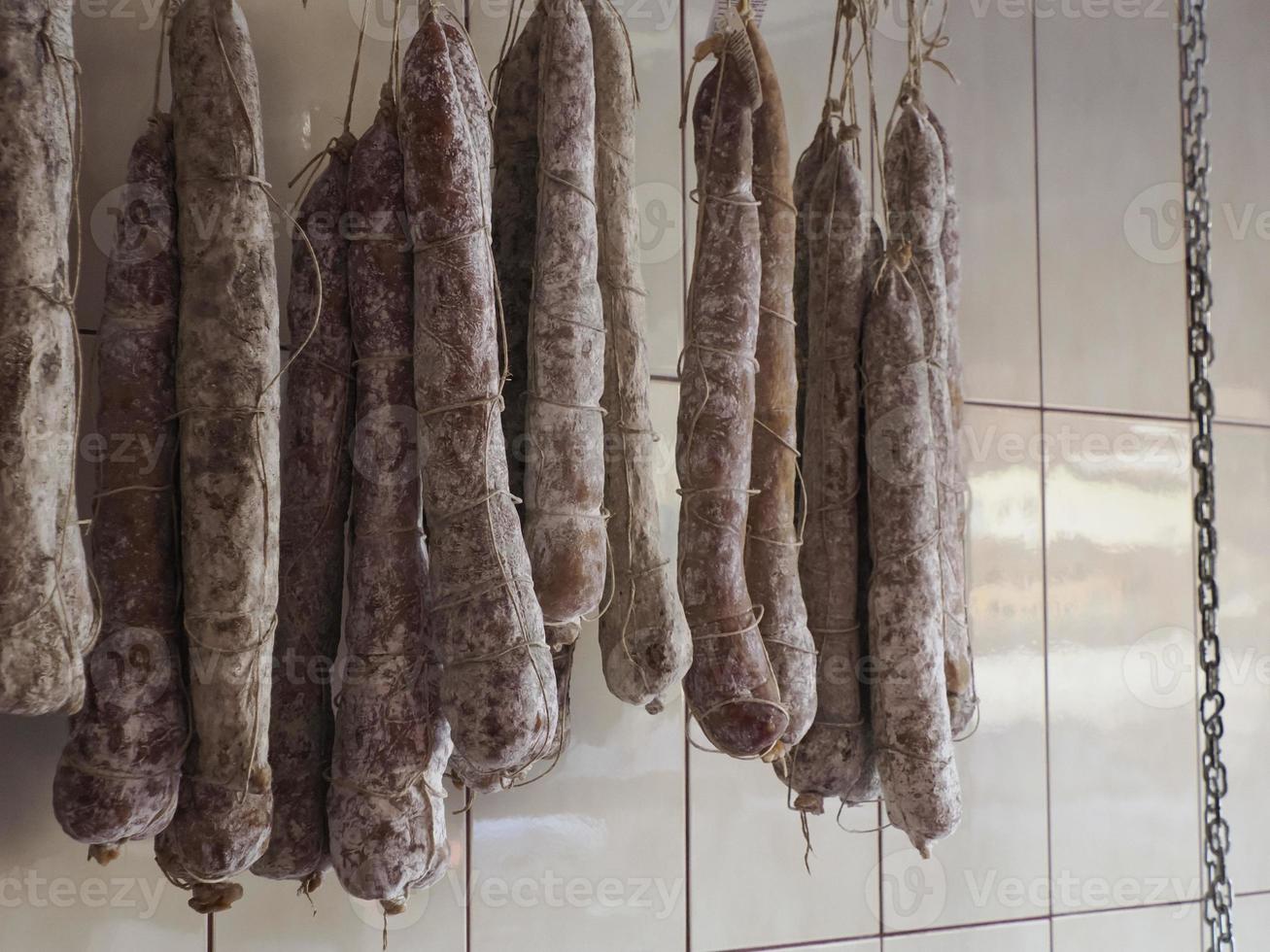 Salami tradicional italiano diferente en la tienda. foto