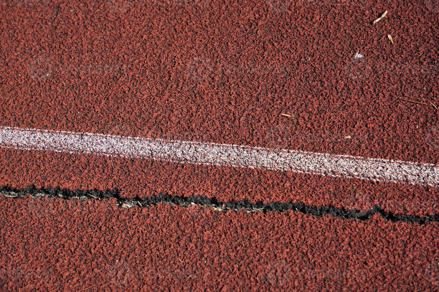 damaged cracked running athletic track detail photo