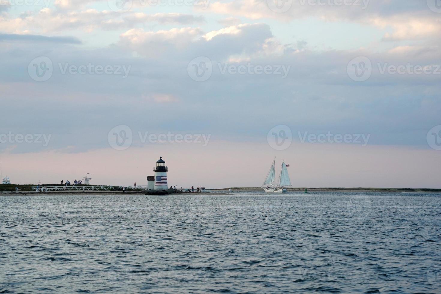 lighthouse of nantucket harbor view at sunset photo