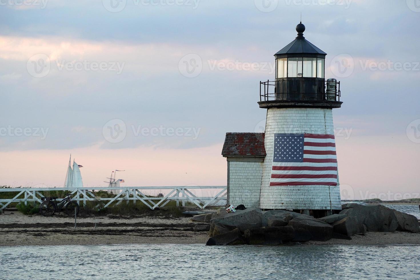 lighthouse of nantucket harbor view at sunset photo