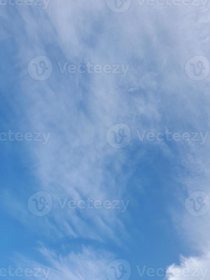 Beautiful white clouds on deep blue sky background. Elegant blue sky picture in daylight. Large bright soft fluffy clouds are cover the entire blue sky. photo