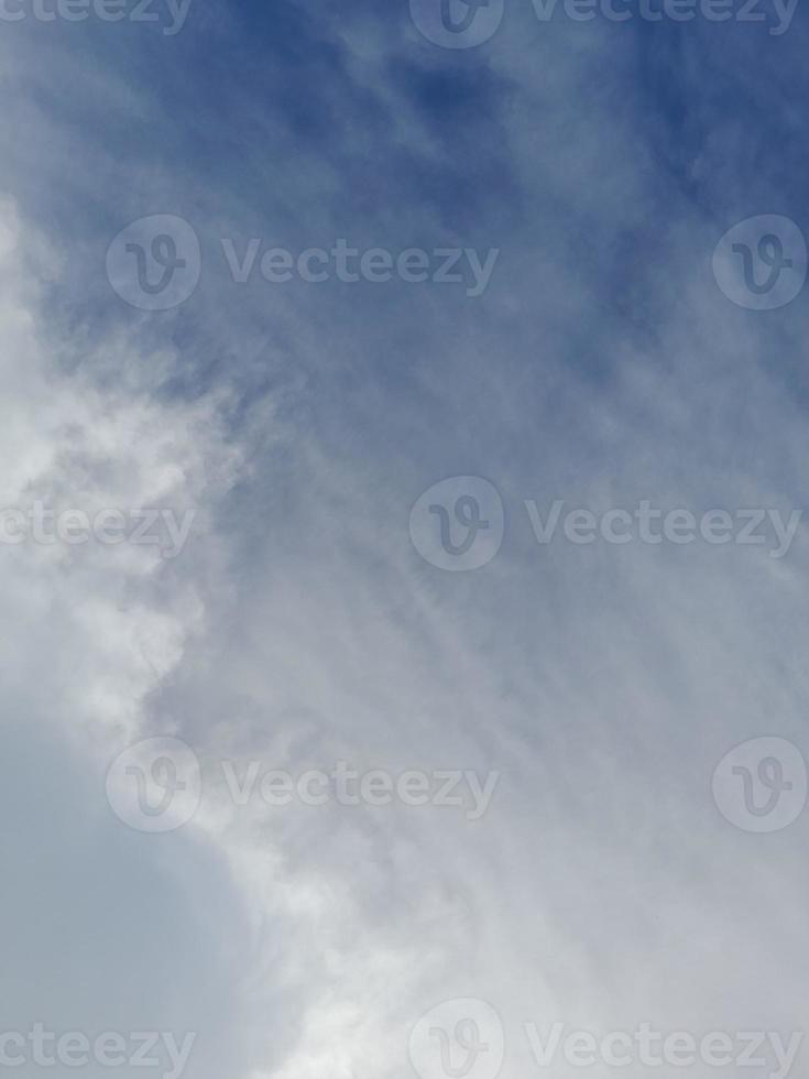 Beautiful white clouds on deep blue sky background. Elegant blue sky picture in daylight. Large bright soft fluffy clouds are cover the entire blue sky. photo