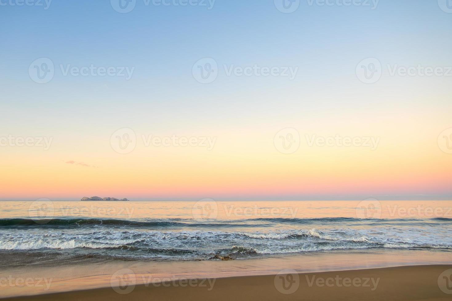 Beautiful sunny and pink sunrise on the beach photo