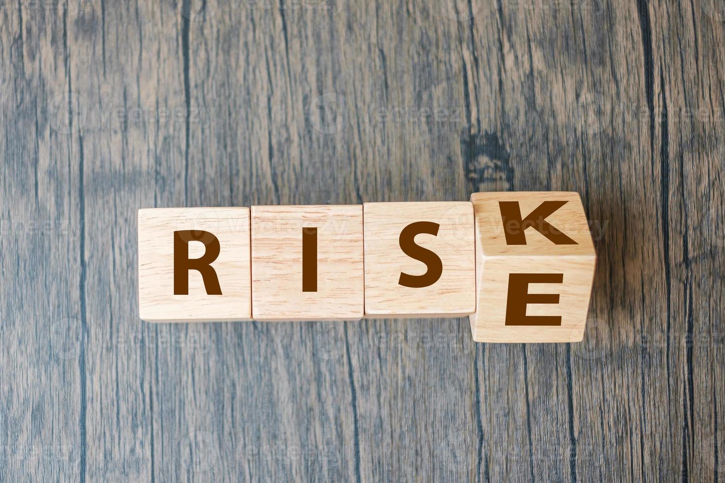 wooden cube blocks with RISK change to RISE text on table background. strategy, analysis, marketing, management, opportunity and Crisis concepts photo