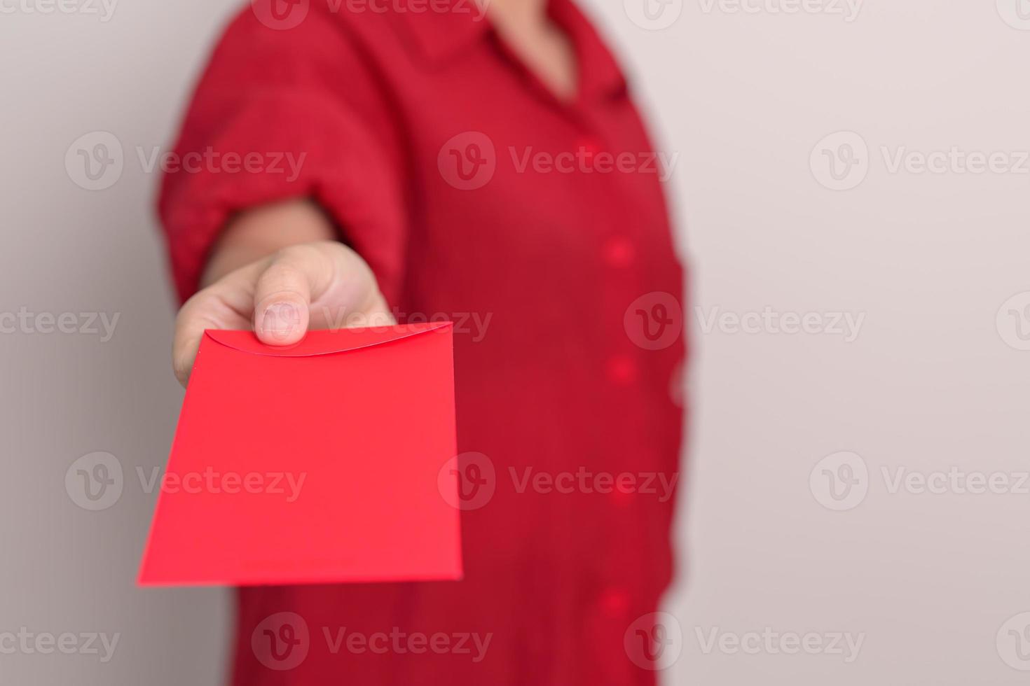 Woman holding Chinese red envelope, money gift for happy Lunar New Year holiday photo