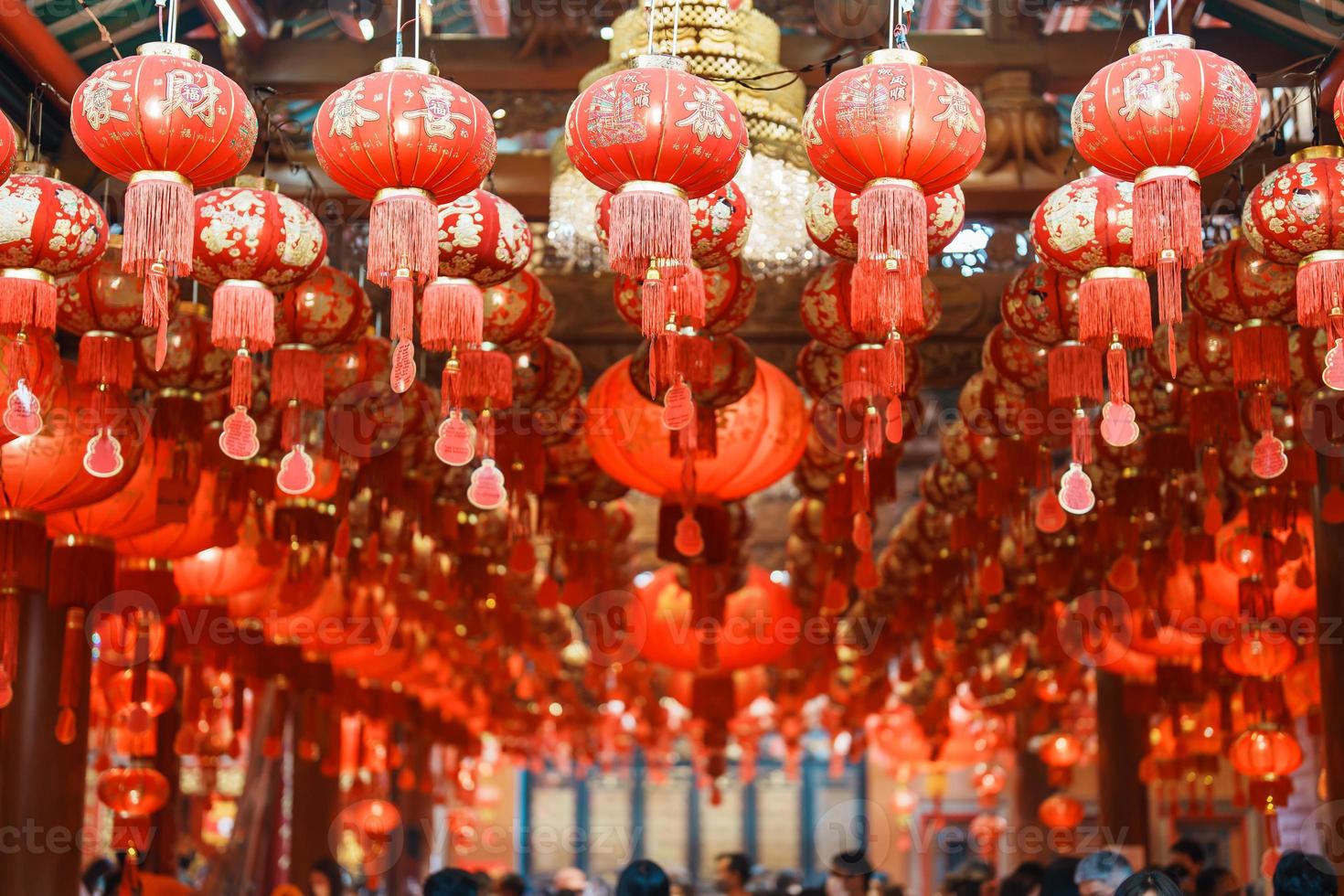 Chinese red Lanterns in temple, happy Lunar New Year holiday. Chinese sentence means happiness, healthy, Lucky and Wealthy photo