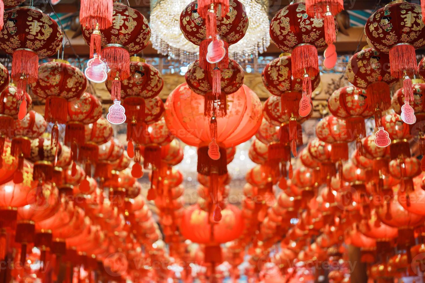 Chinese red Lanterns in temple, happy Lunar New Year holiday. Chinese sentence means happiness, healthy, Lucky and Wealthy photo