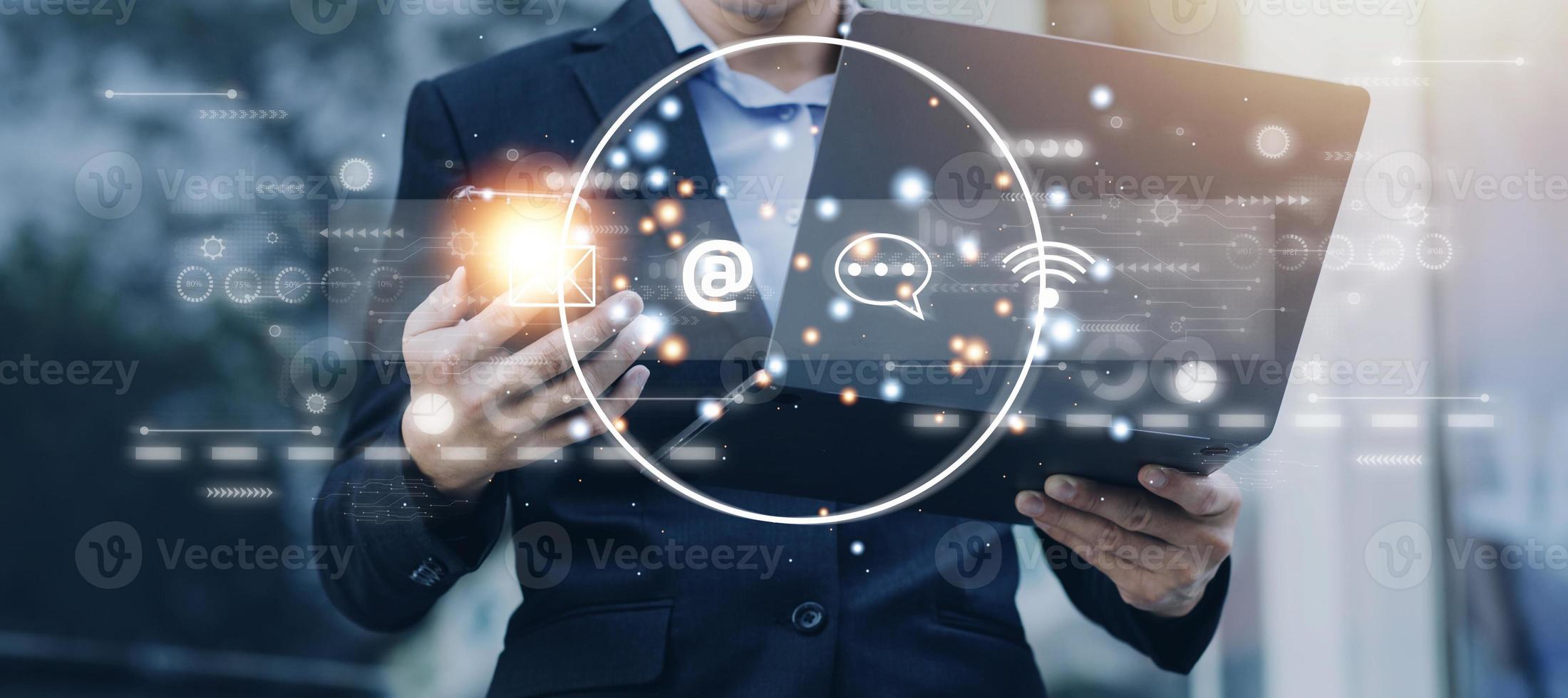 Contact us or Customer support hotline people connect. Businessman using a laptop and touching on virtual screen contact icons email, address, live chat, internet wifi . photo