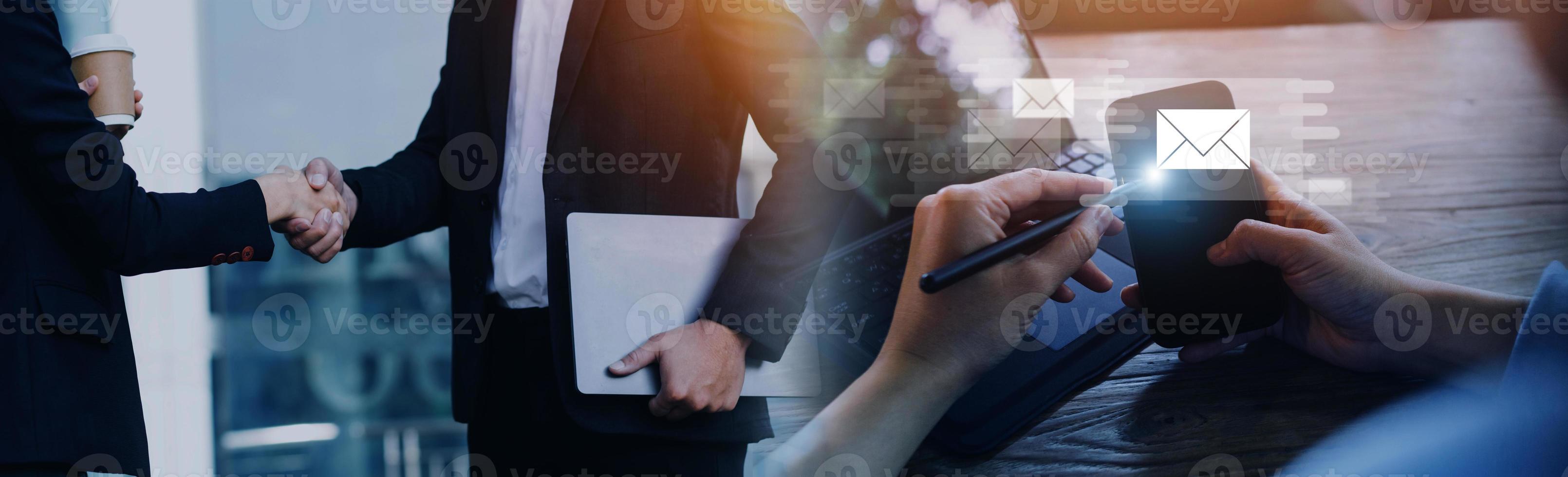 Businessman hands using Laptop typing on keyboard and surfing the internet on office table with email icon, email marketing concept, send e-mail or news letter, online working internet network. photo
