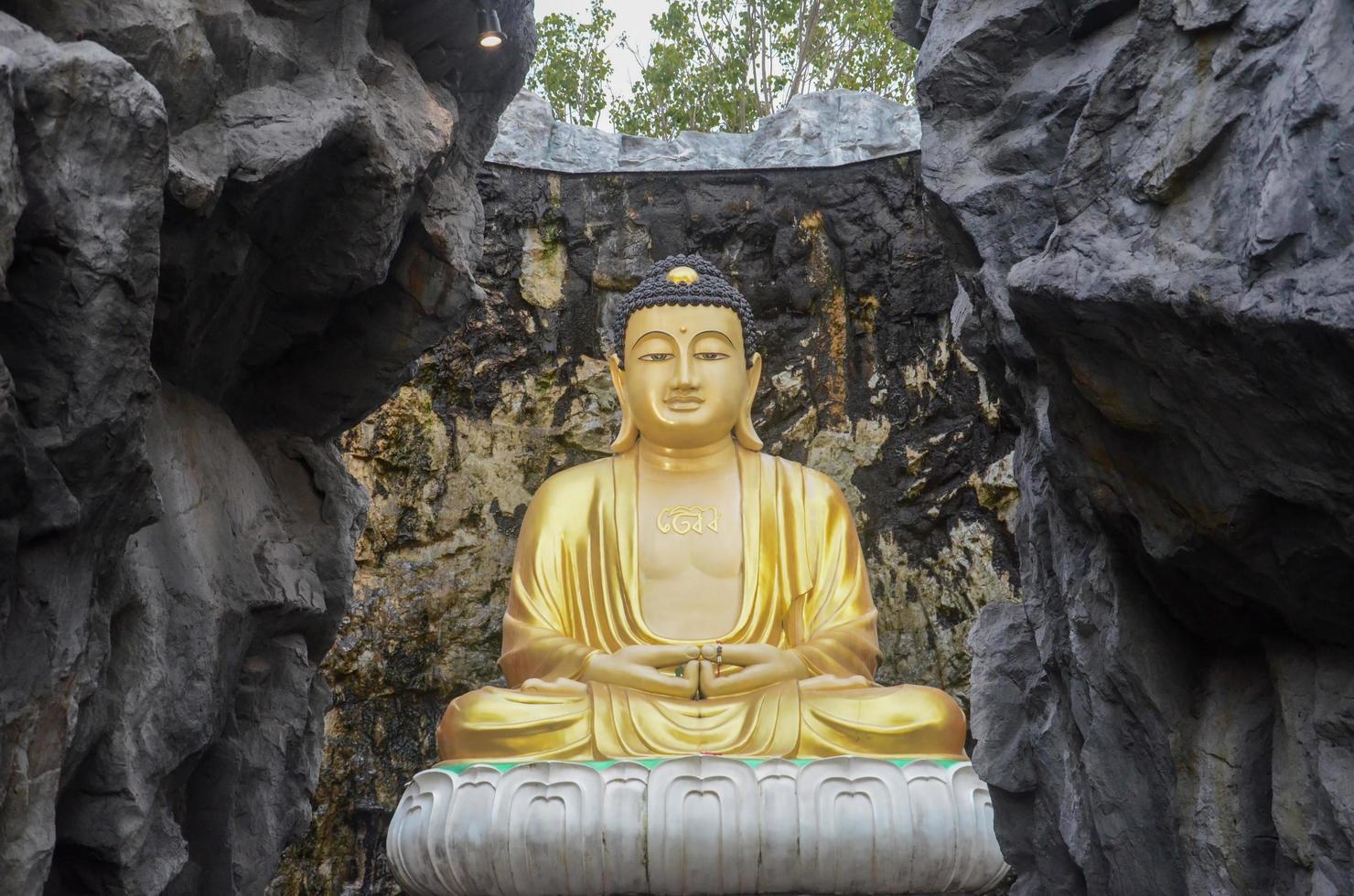 Luang Por To Mahayana, at Wat Lak Si Rat Samosorn, surrounded by model mountains photo