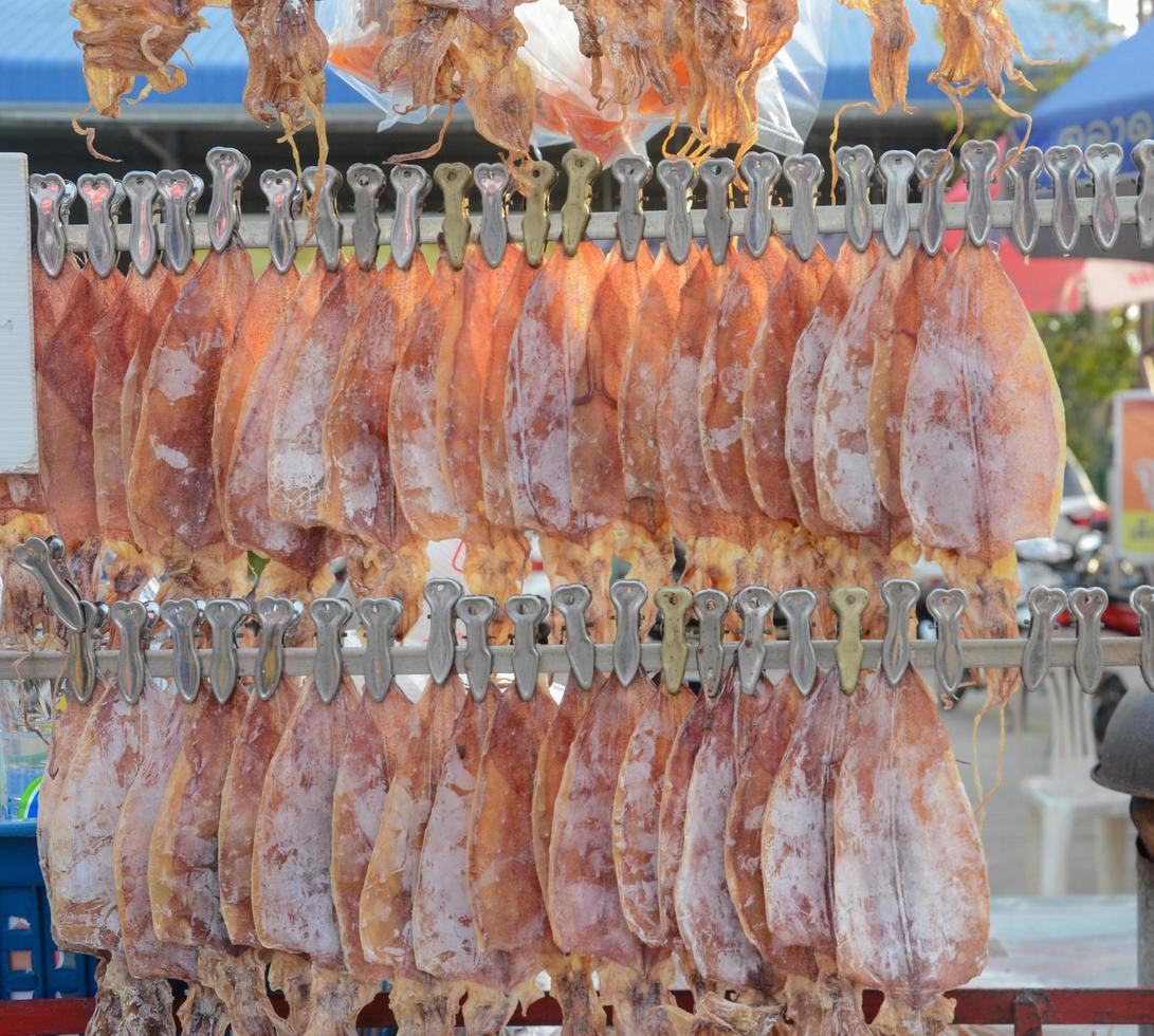Dried squid, sold on a cart at the local market, grilled and ground before being eaten. photo