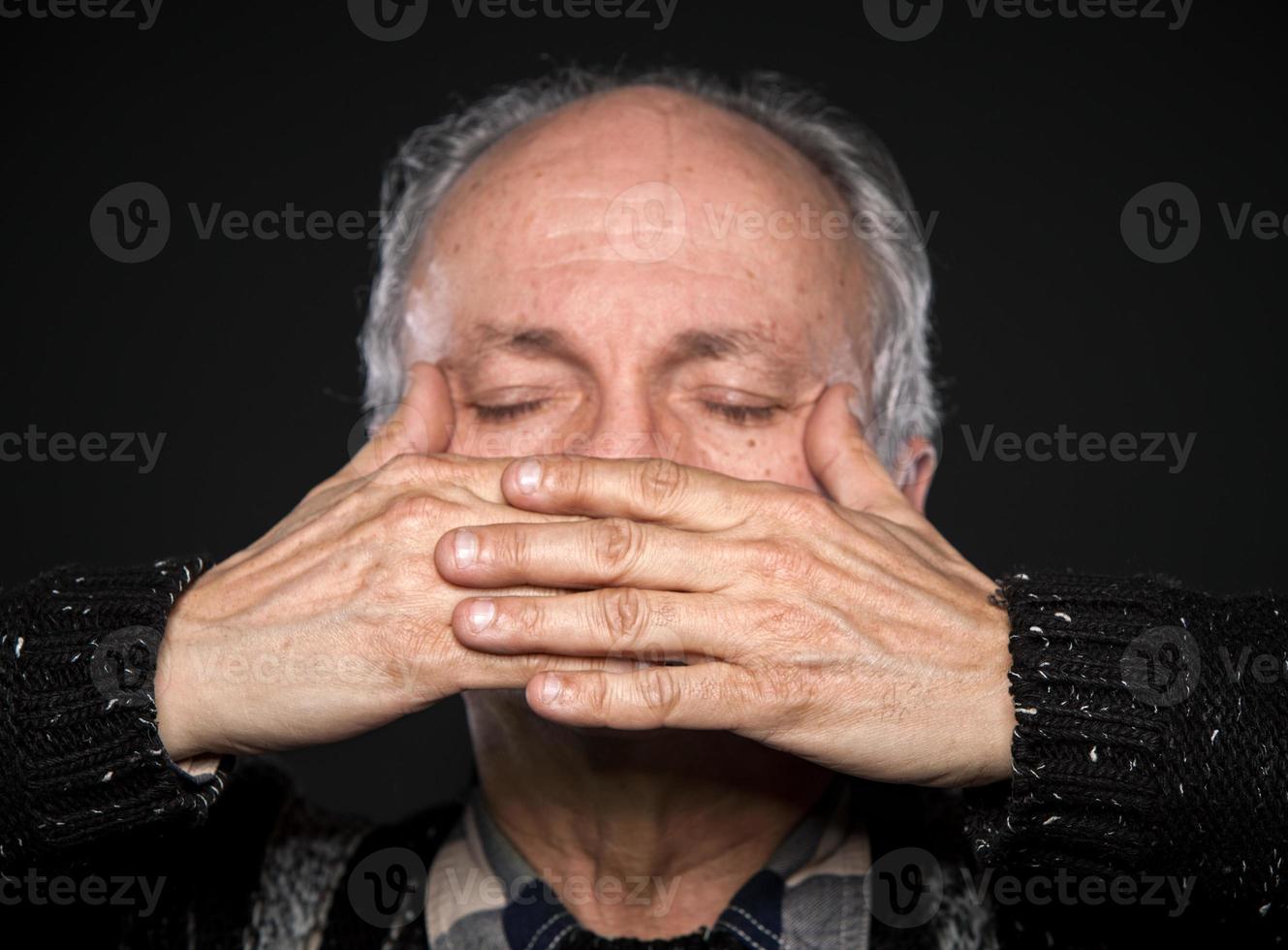 elderly man with closed eyes photo