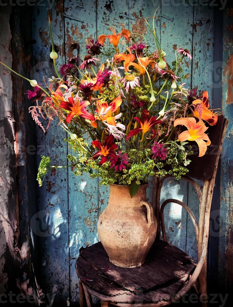 Romantic bouquet with daylilies, echinacea, astilba, parsnips, garlic  and monarda photo