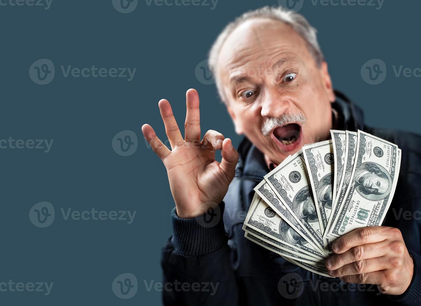 Happy elderly with fan of money photo