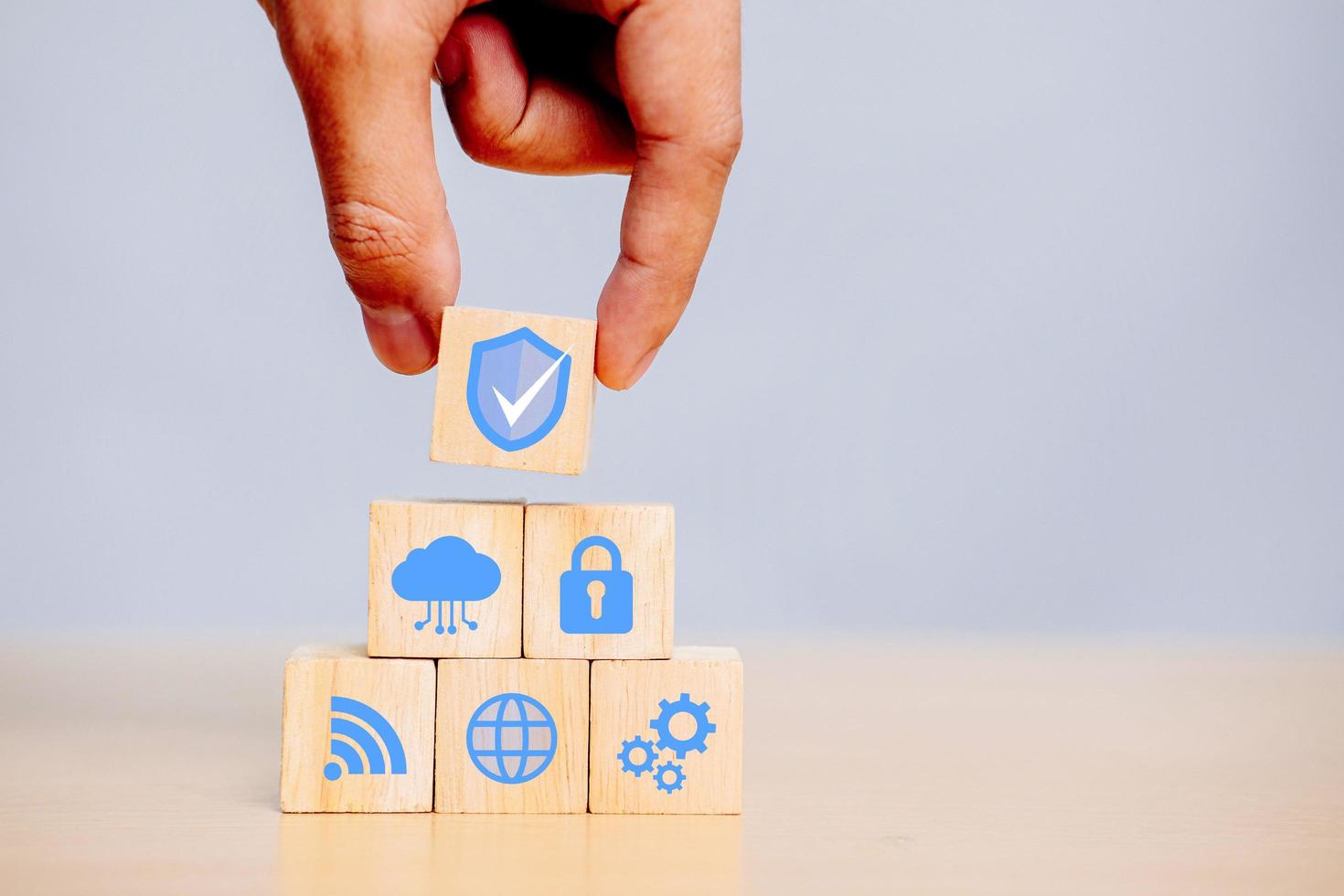 Hand holding wooden cube with icons security, Cybersecurity protection and data security concept with document icons. photo