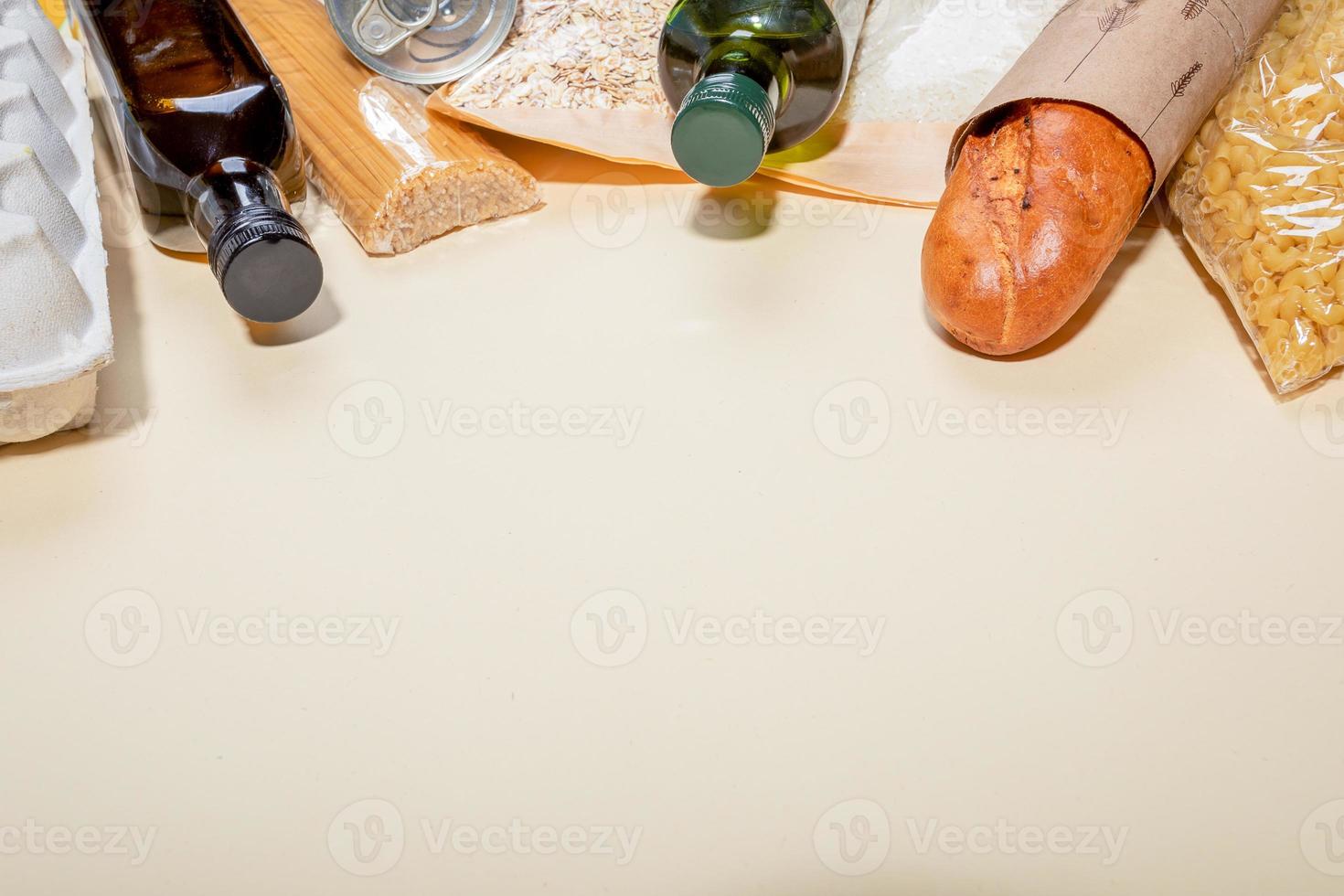 Stock of food products in eco-friendly paper, cellophane, glass packagings laid out on beige backdrop. Copy space. photo
