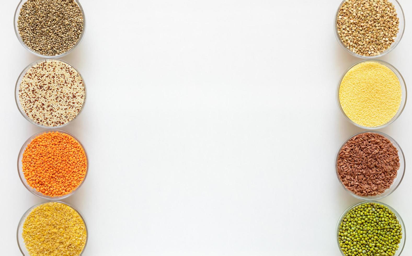 Two rows of glass bowls with superfoods on white background with copy space. photo