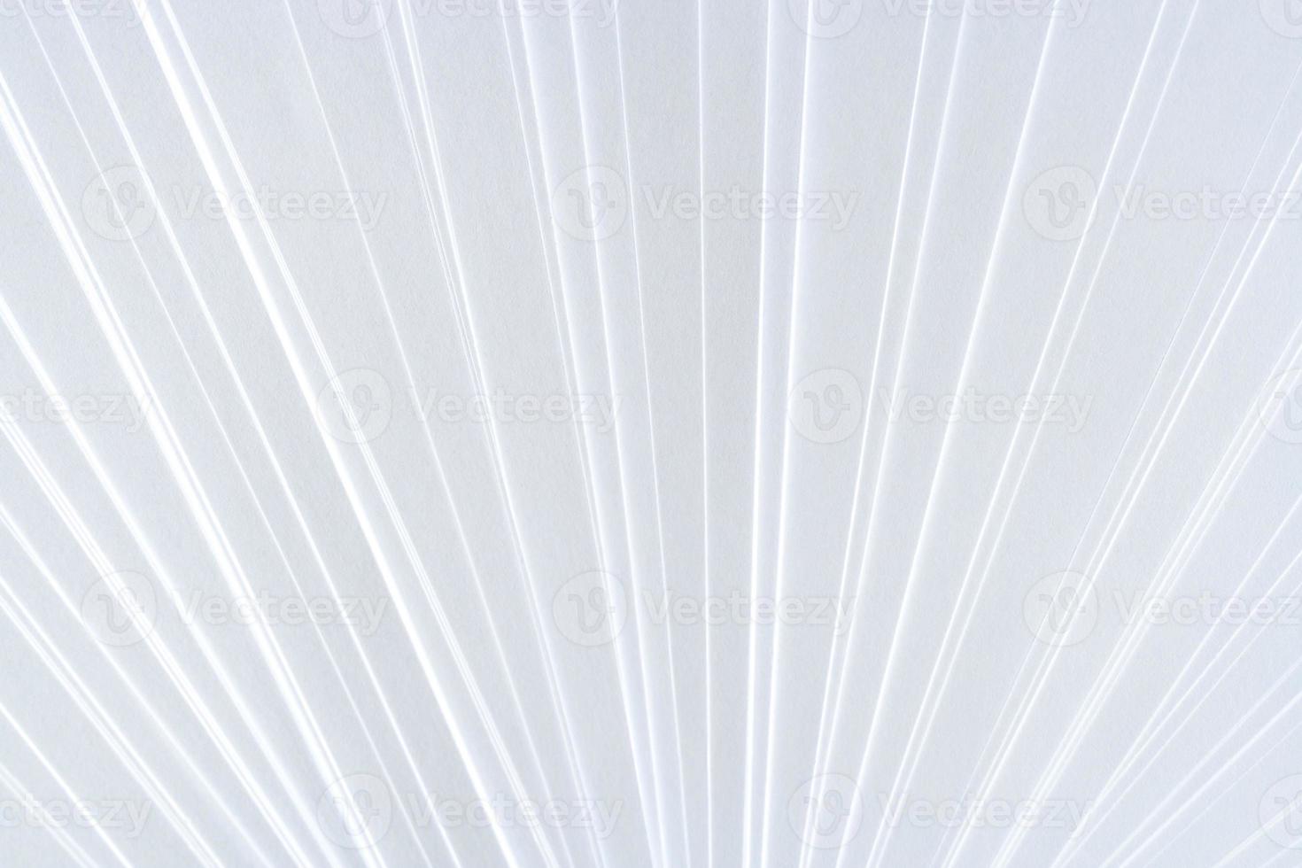 White symmetric geometric pattern of clean paper sheets, spaced as fan. photo