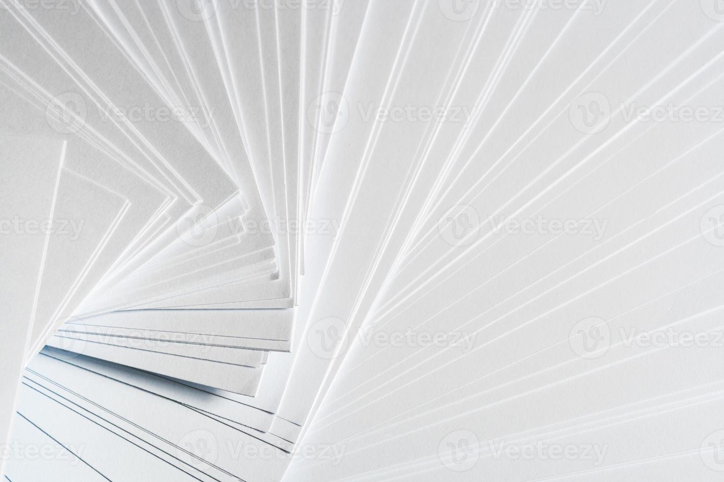 White background from stack of clean sheets  paper, laid out randomly in a spiral. photo